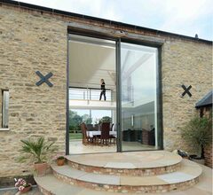 Automated double height sliding glass doors