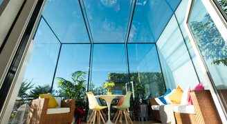 Large frameless structural glass roof extension