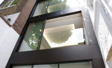 integrated balustrade into sliding glass doors as part of three storey glass extension in London