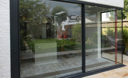 a patio door with a frameless glass corner