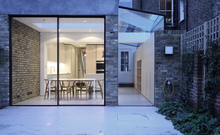 Slim glass patio doors with frameless glass side infill extension