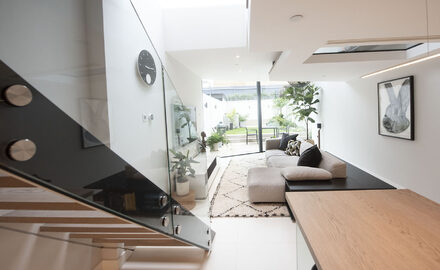 Frameless structural glass balustrades to internal staircase and modern living room