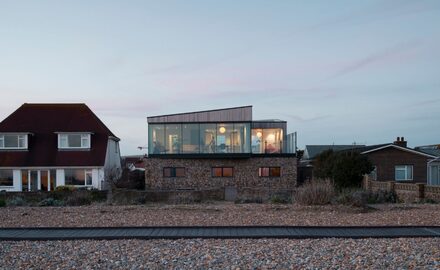 bespoke house on old fort road right on the beach shown at dusk