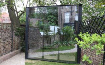 Oversized glass mirror door to garden room