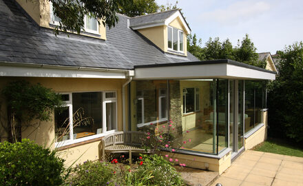 Rear home extension with sliding patio doors and fixed minimal glazing
