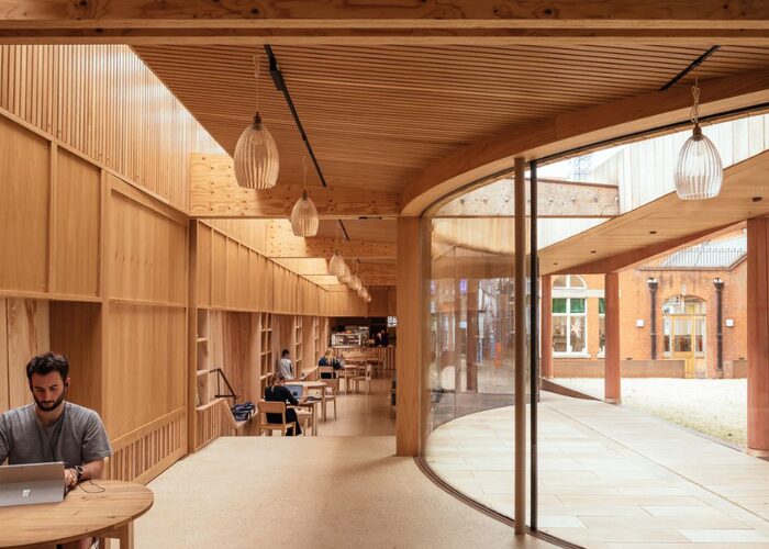 Lea Bridge Library timber and curved glazing with wide apertures in the frameless glass facade