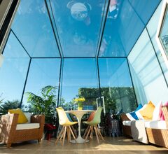 Large frameless structural glass roof extension