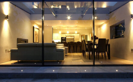modern highly glazed home extension design with minimally framed sliding doors