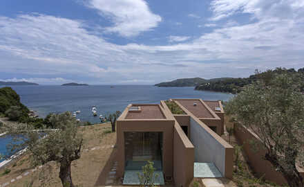 Minimal sliding glass doors to terracotta Greek island house