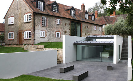 Contemporary barn conversion project with oversized sliding glass doors and a modern glazed extension