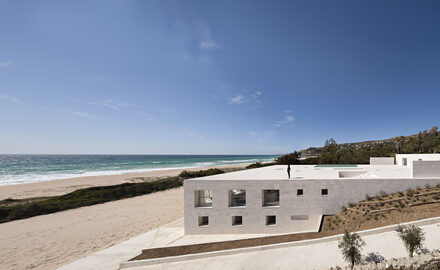 Spanish coastal home with minimal glass windows and slim sliding glass doors